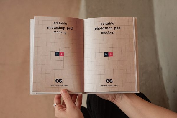 手持展开的精装书籍样机