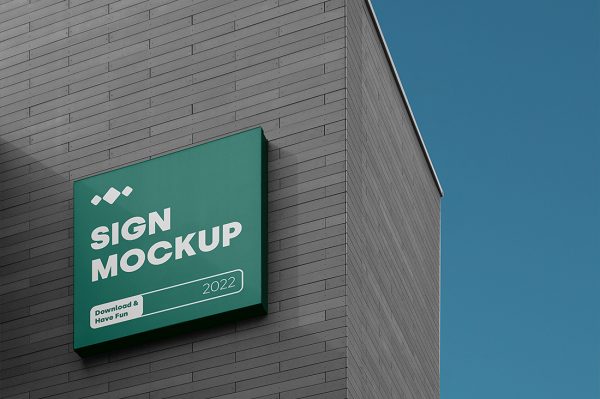 在建筑墙面上的招牌店招标识牌样机mockup